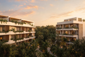 Dos edificios de departamentos entre vegetación tropical en Tulum al atardecer